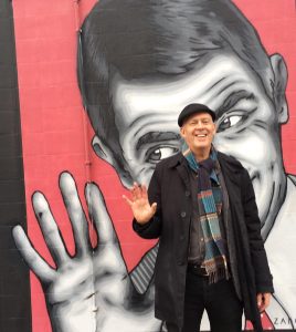 Picture of street art, with George in front of it.